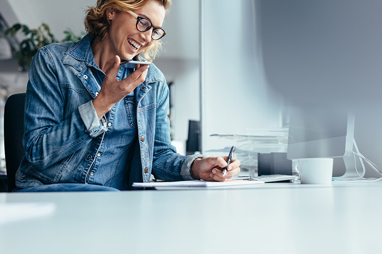 Mobile worker using smart phone and taking notes